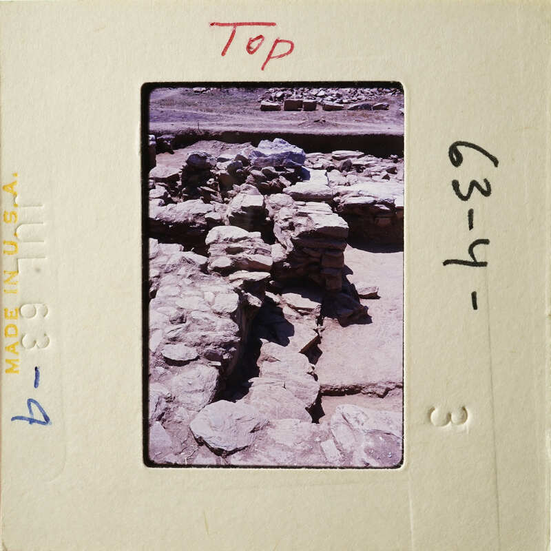 Old ruins with stone structures and shadows, on a photographic negative strip.