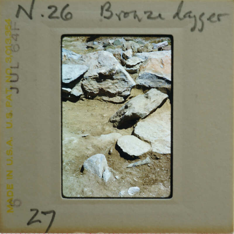 A photograph of a rocky terrain with a label on the front.