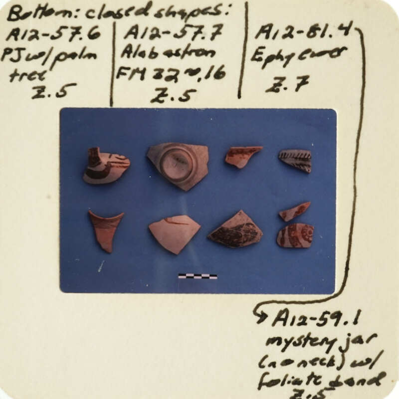 Collection of ancient pottery fragments with labels and notes.