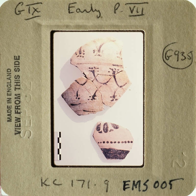 Small ceramic shards with designs on them, possibly from ancient pottery.