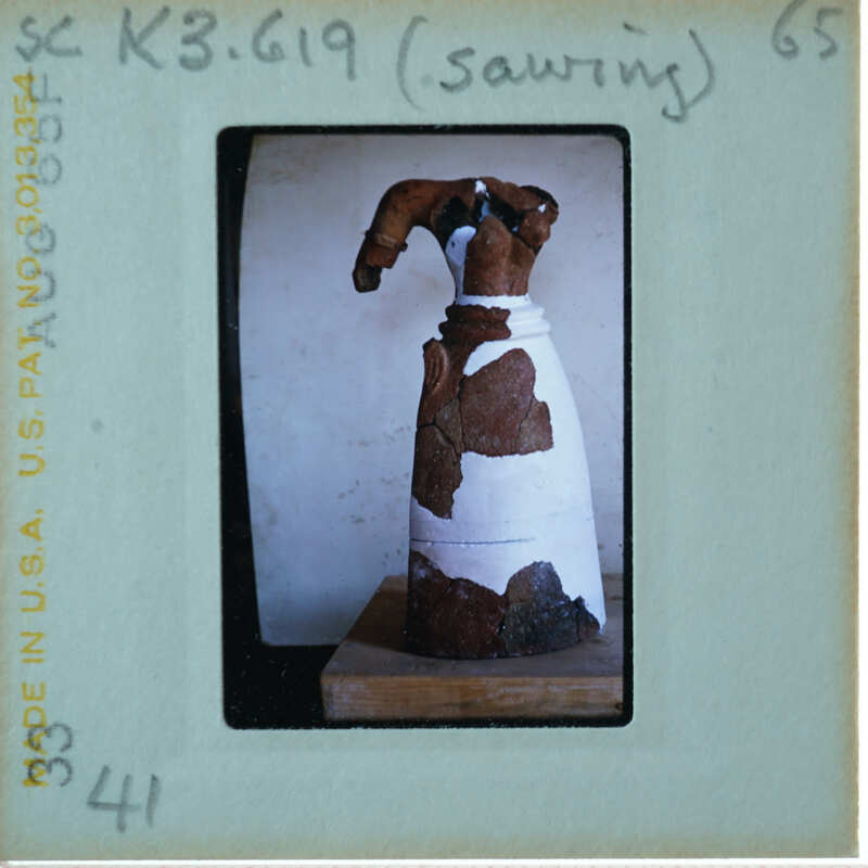 Headless restored terracotta figuring from front.