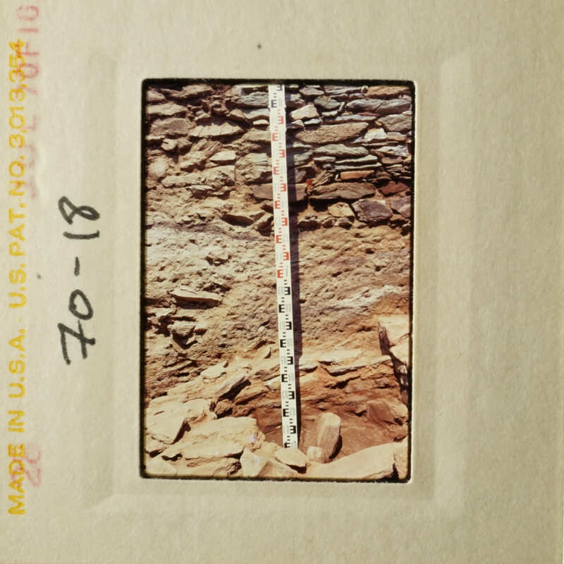 A ruler placed on top of a rocky surface, showing scale.