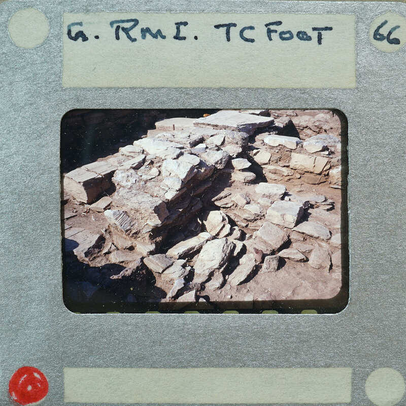 Old photo of a stone wall with handwritten text on the border.