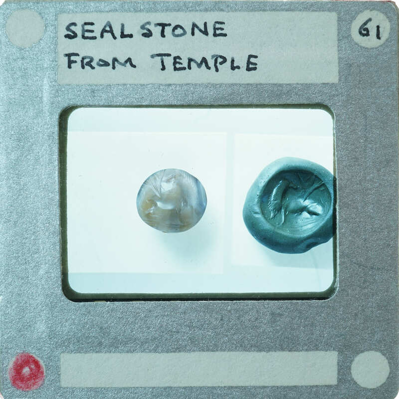 Circular stone object on left with carvings, seal impression on right.