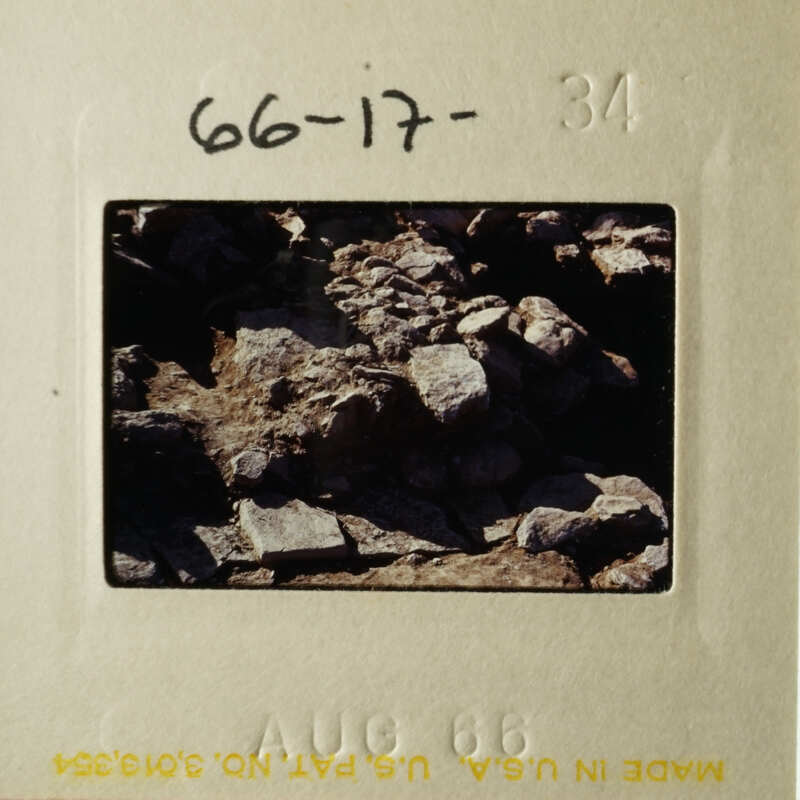 The photo shows a rocky terrain with a close-up view of rocks and debris.