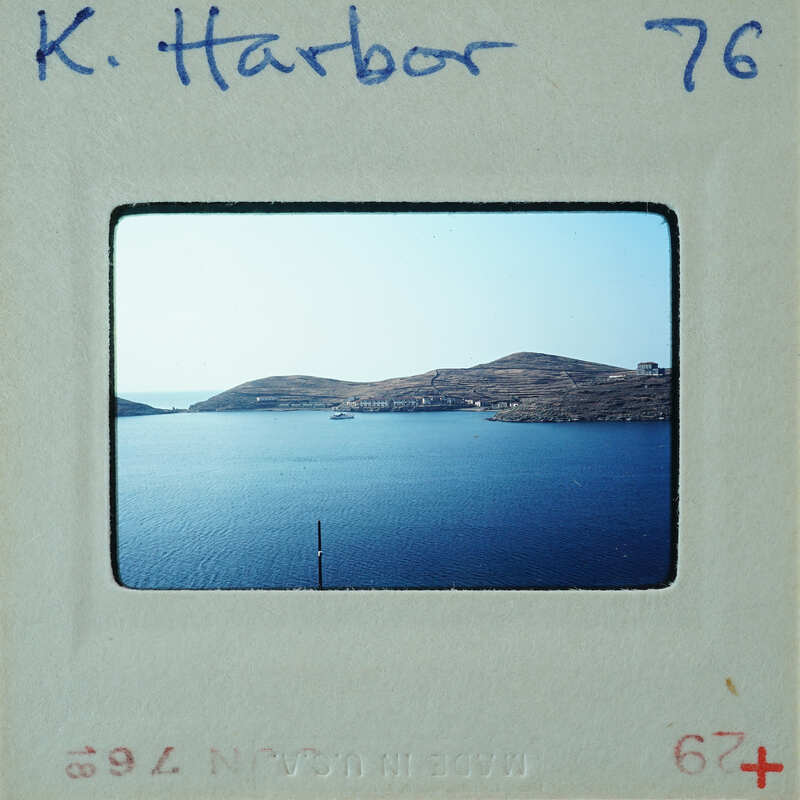 A vintage photo of a harbor with islands and blue water, labeled "K. Harber".