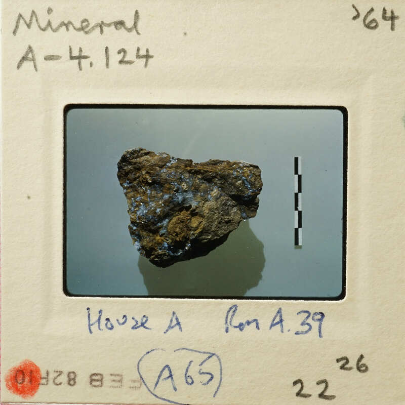 Image of a rock with blue crystals, possibly a mineral specimen, on a white background.