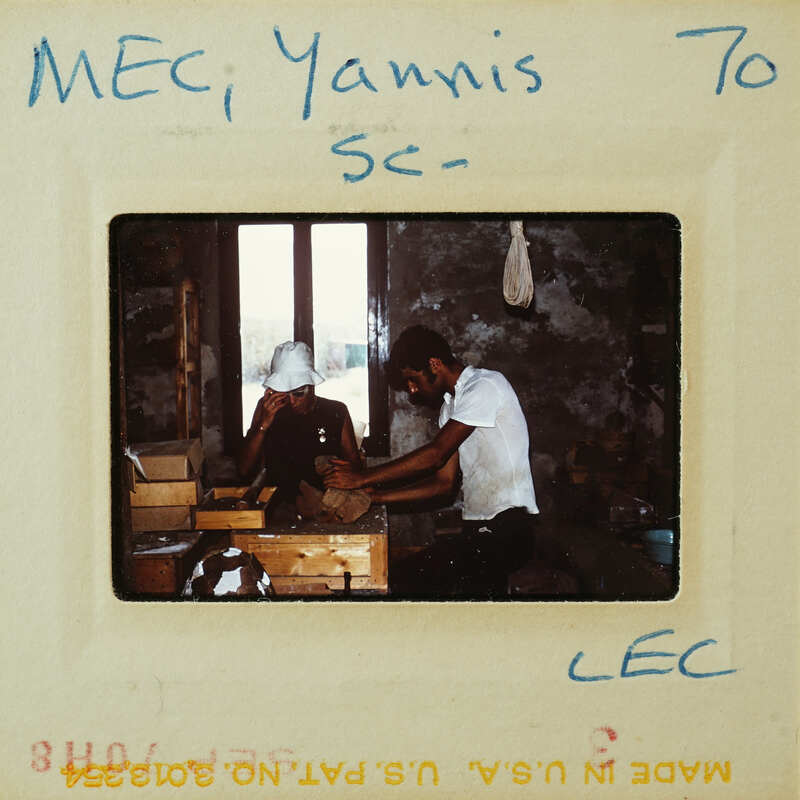 Man and woman working on a wooden object together.