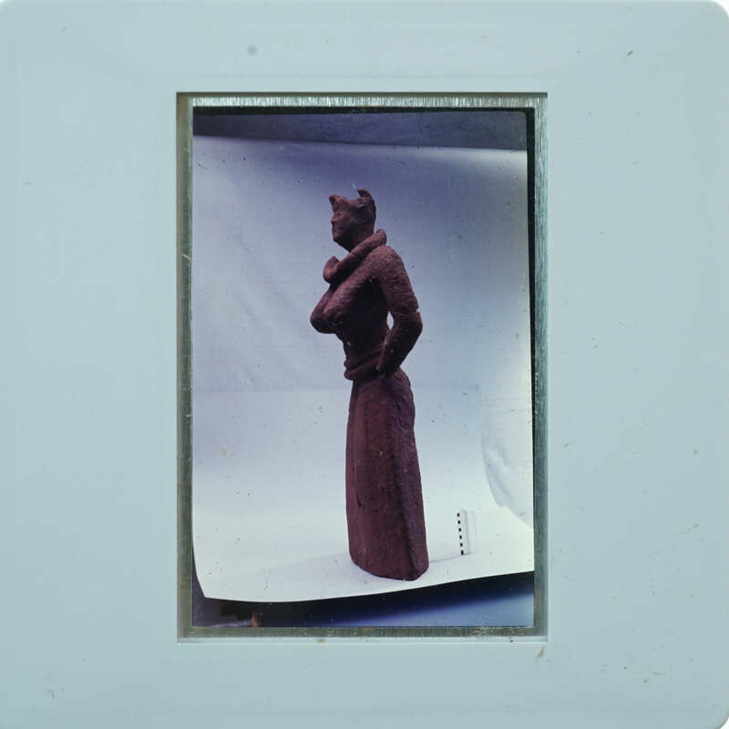 Detail of almost complete terracotta figurine from the side minus right arm.