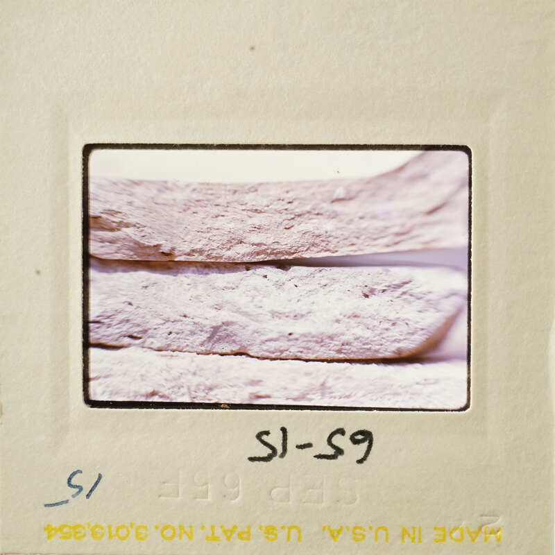 Close-up photograph of a pottery break surface on a film strip.