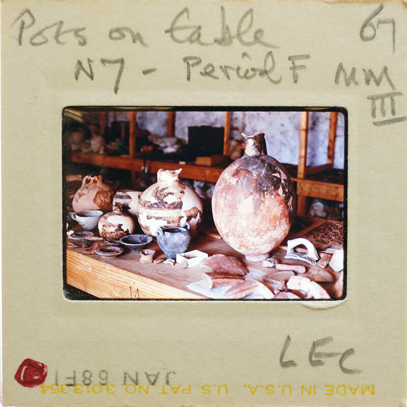 A photograph of a table with various pottery items, including vases and bowls.