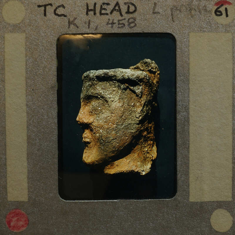 Profile of broken terracotta head from figurine, looking left; K1.458.
