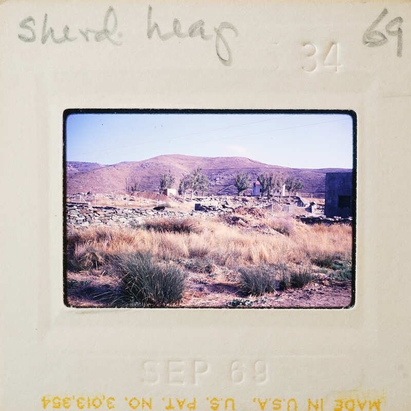 A vintage photo of a barren landscape with sparse vegetation and distant mountains, dated September 1969.