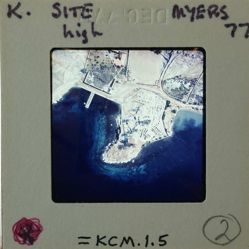 Aerial photograph of a coastal area with land and water.