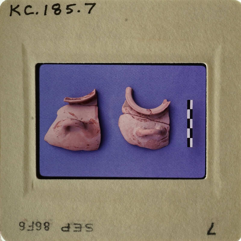 Two ancient clay figurines on display.