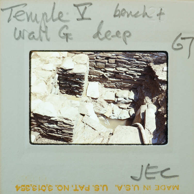 Stone walls and bench with flooded floor.