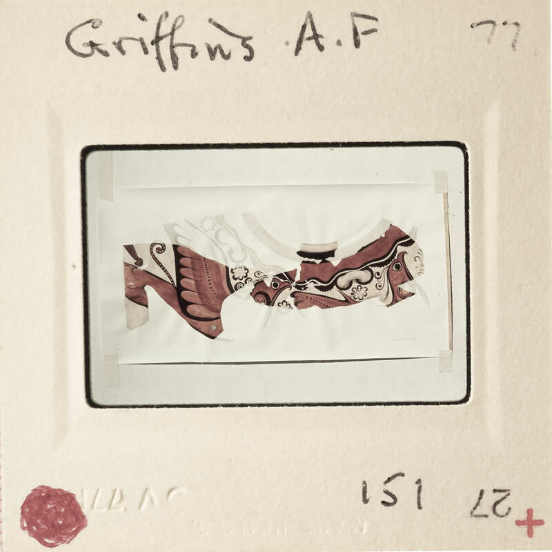 A framed and matted artwork with a label on the bottom right corner.