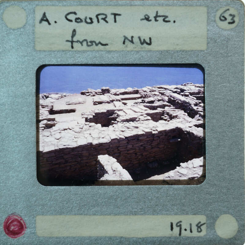 Old photograph of a stone ruins with a label and date on the front.