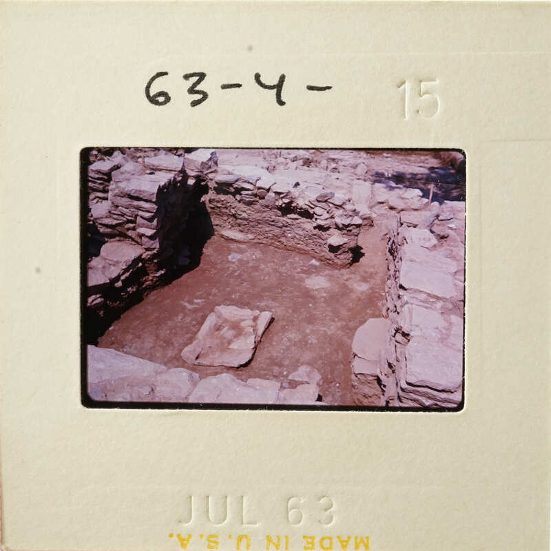 Old photograph of an excavated archaeological site with stone ruins and dirt, dated July 63.