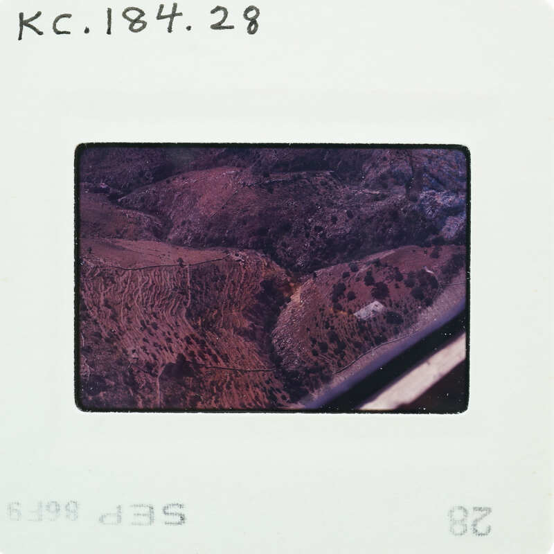 Aerial photo of a mountainous landscape on an old film strip.