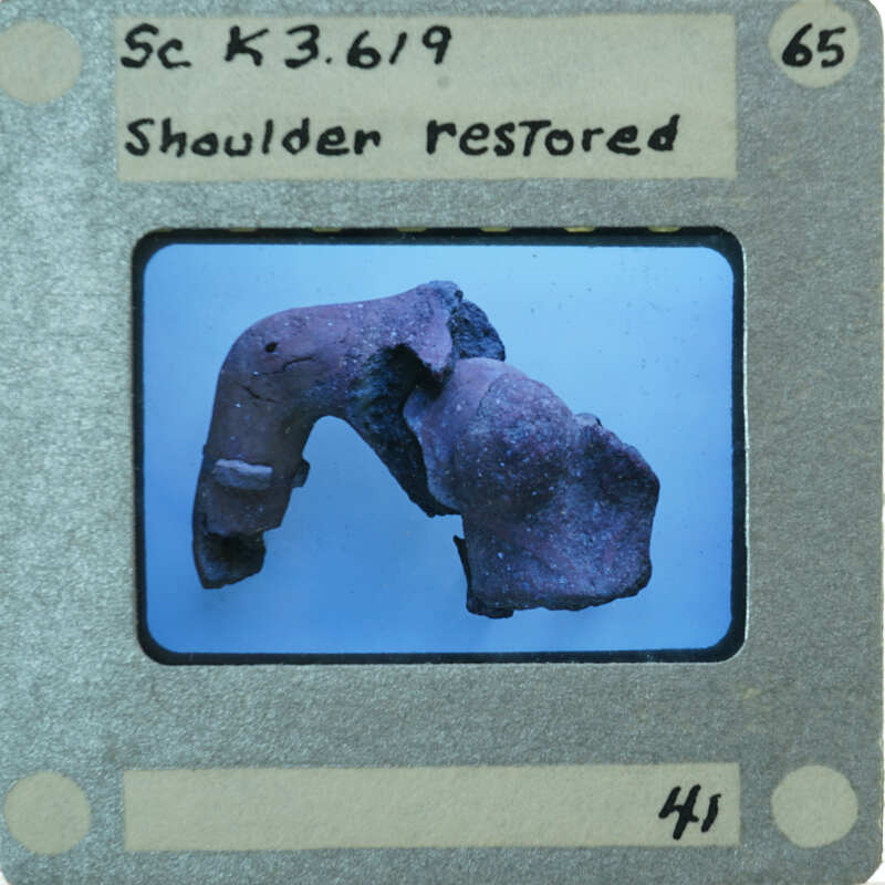 Terracotta fragments showing shoulder of figurine.
