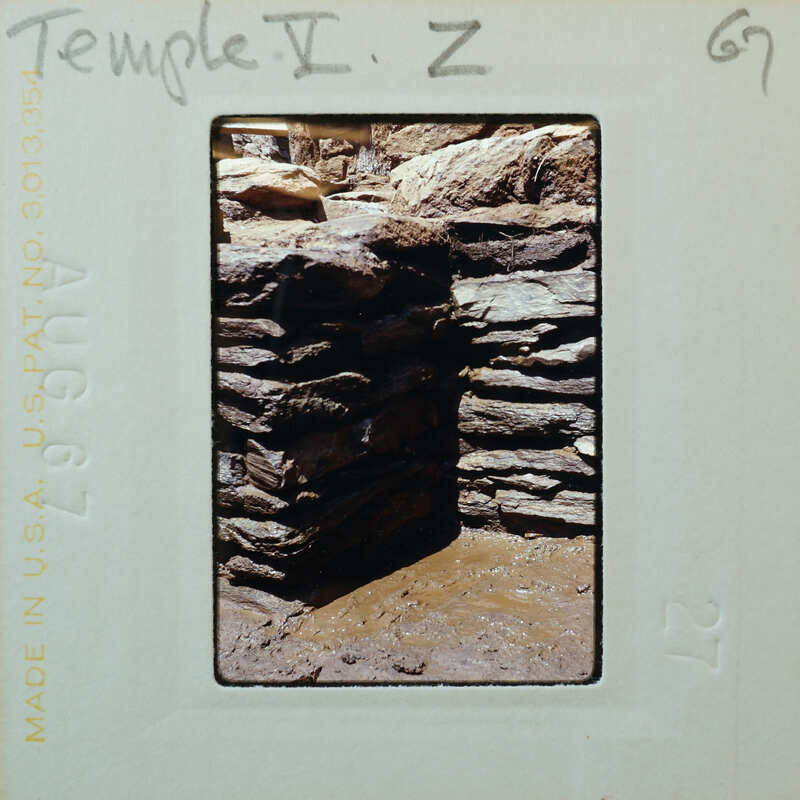 Stone walls and muddy floor.