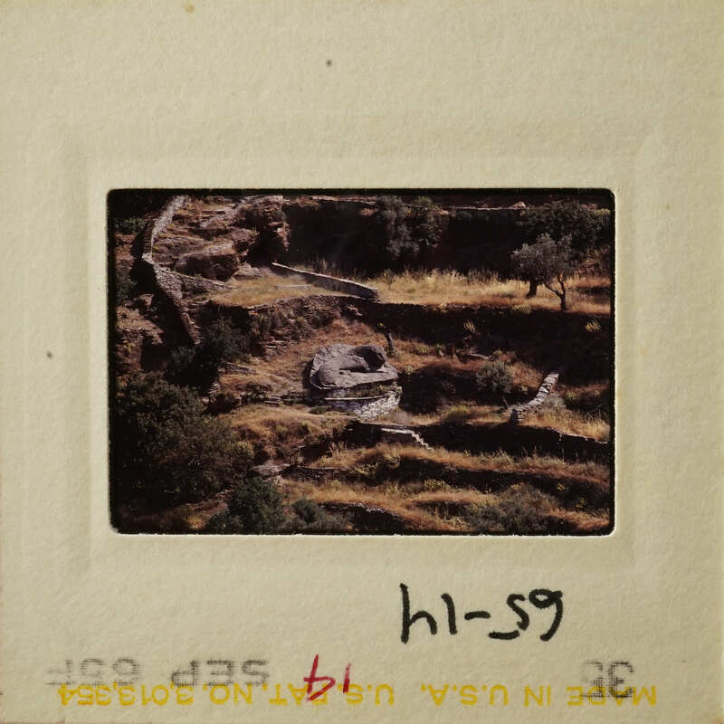 Aerial view of an agricultural landscape with terraced fields and a river.