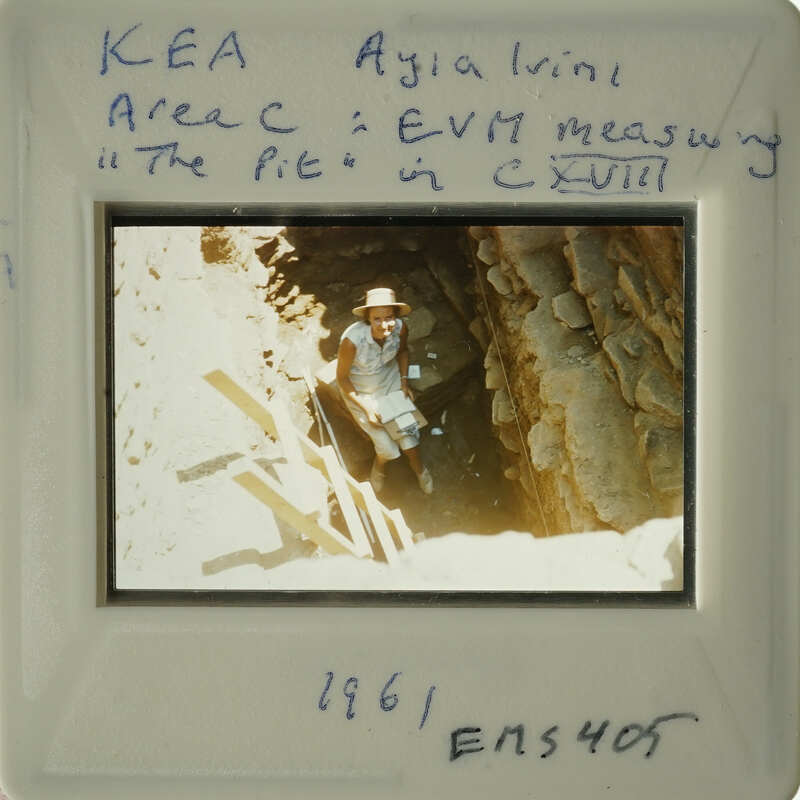 A person standing at the entrance of an underground cave with natural rock formations.