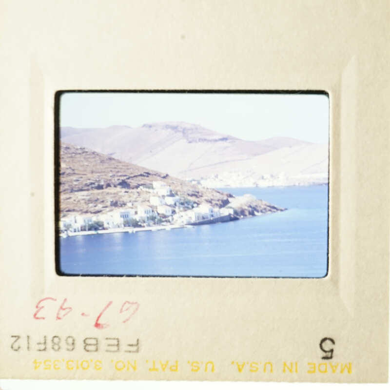 This is an image of two photos placed side by side, showcasing a scenic view of a coastal town with a body of water and mountains in the background.