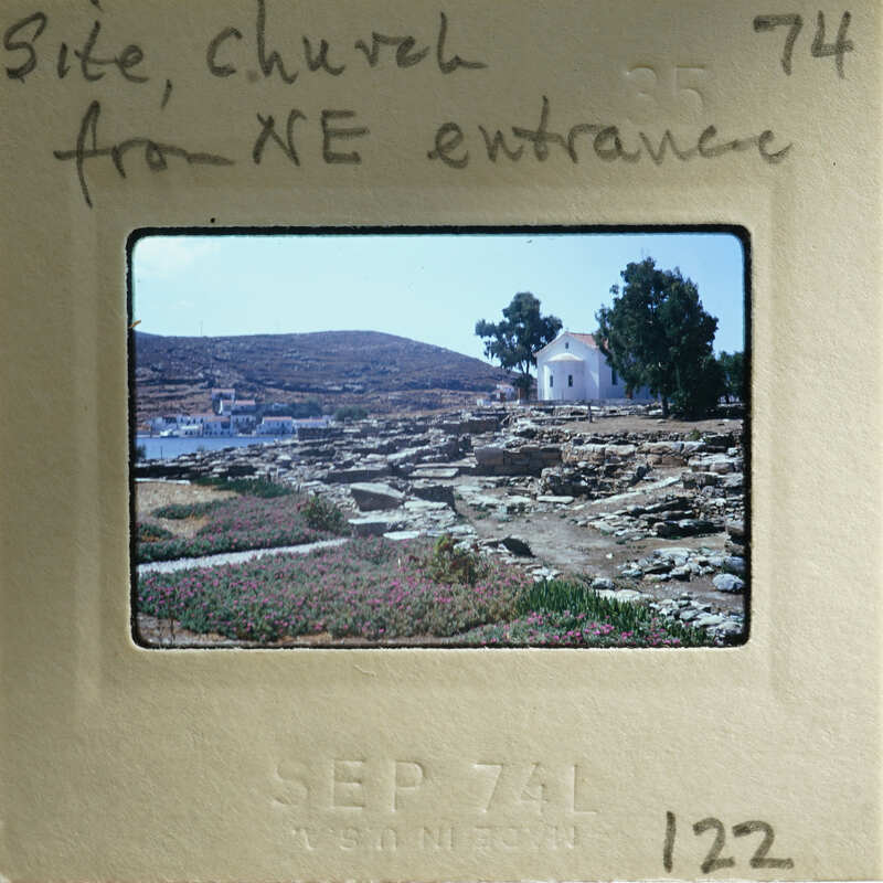 Old photograph of a church with mountains and trees, dated September 74.