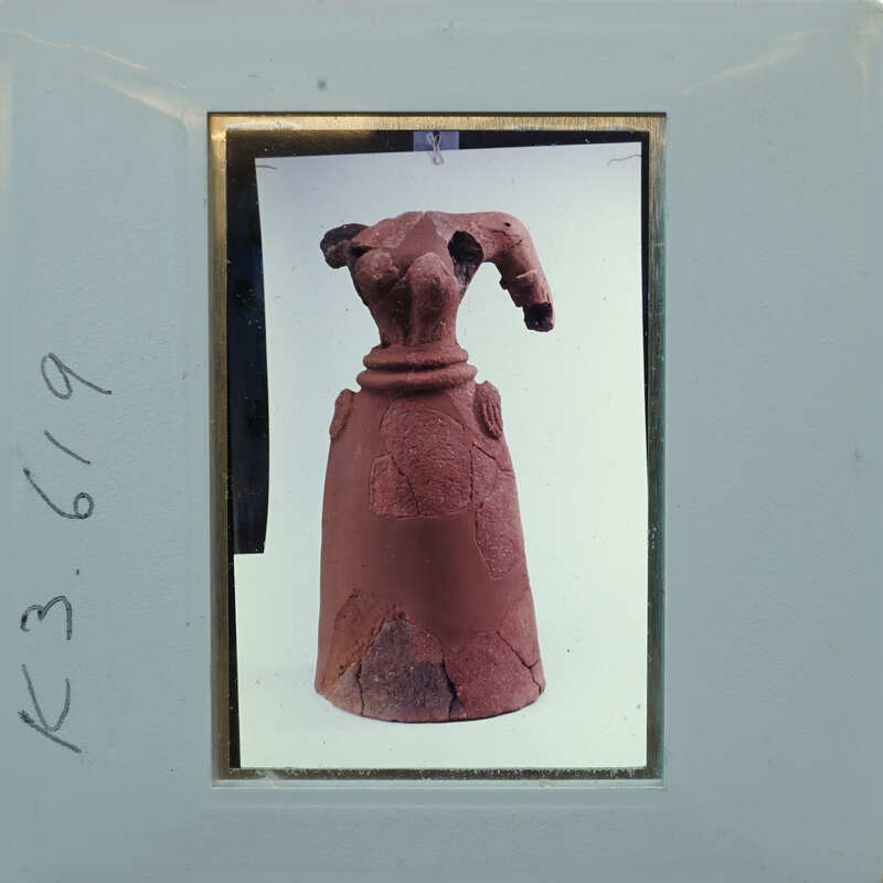 Terracotta headless figurine from 3/4 view front K3.619.