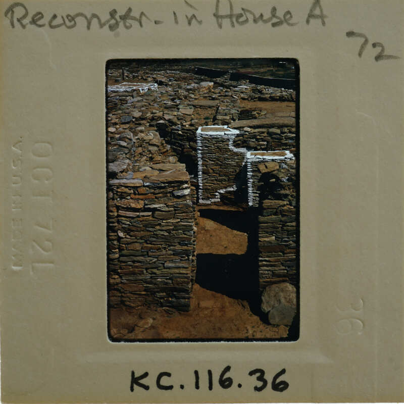 Photo of a stone structure with a white roof on a film strip.