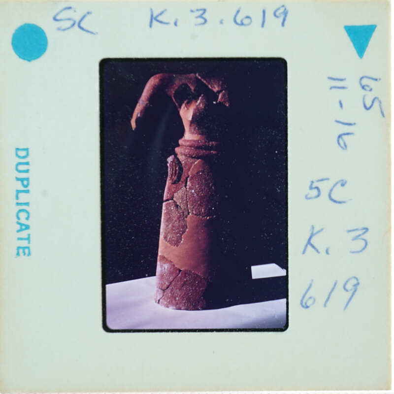 Headless restored terracotta figuring from front.