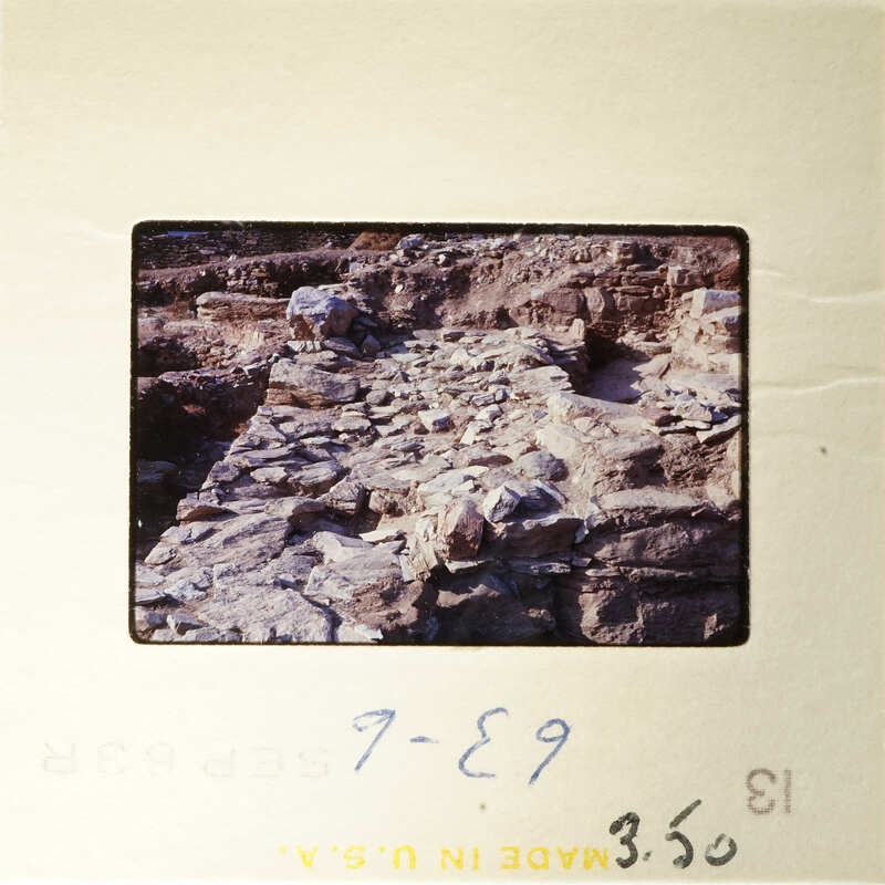 A photograph showing an ancient archaeological site with rock formations and ruins.