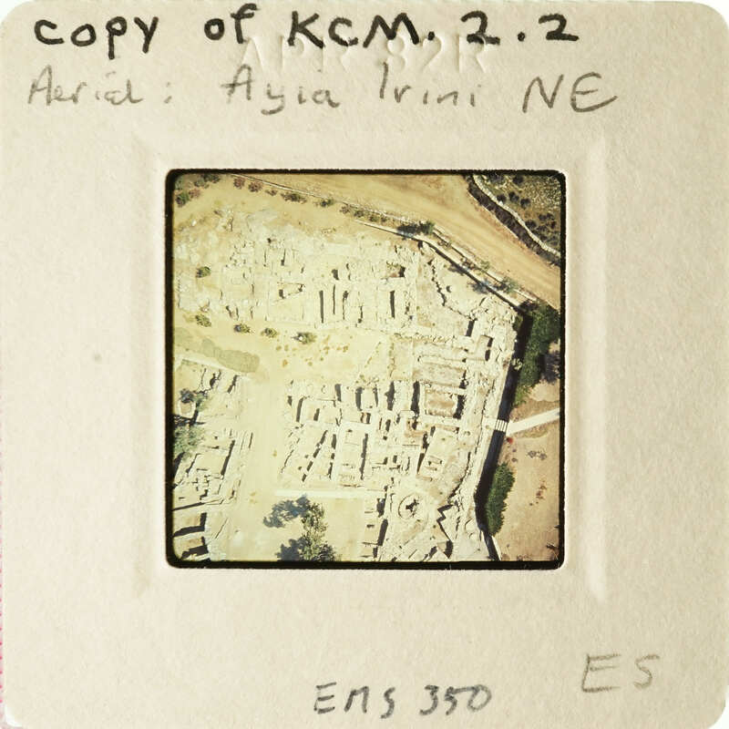 An aerial view of an archaeological site with ruins and vegetation, captured on a vintage photographic slide.