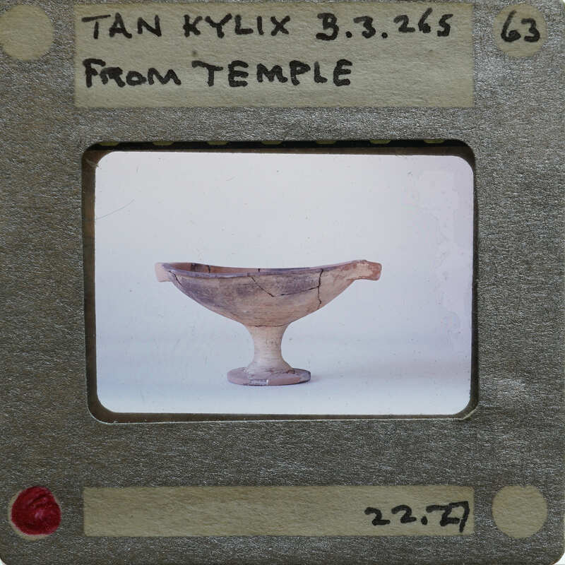 A kylix with a label indicating it's from Temple, displayed on a table.