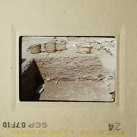 Two photos showing an archaeological site with artifacts and a stone foundation.