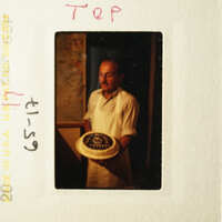 Man holding a cake.