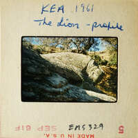 Rock formation with sunlight casting shadows and highlights.