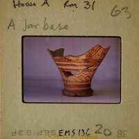 A broken ancient Greek vase with visible patterns and colors.