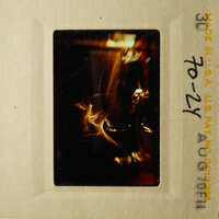 A vintage photograph showing a close-up view of a blurry object with a dark background.