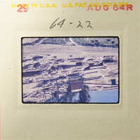 Old photograph of an archaeological site with ruins and excavated areas.