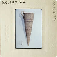 Ancient ceramic artifact on display with photographic documentation.