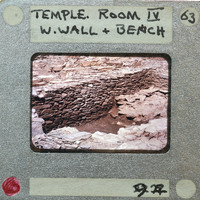 A photograph of an ancient stone structure, possibly a temple or ruins, with handwritten labels on the back.
