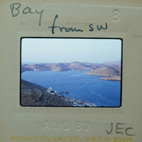 Photo of a coastal landscape with a body of water, hills, and buildings, taken on August 17, 1987.