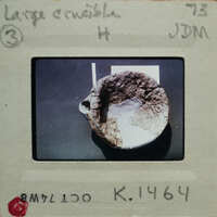 Picture of a broken pottery bowl on a table, with an envelope surrounding it.