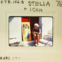 A woman sitting on steps with a religious icon behind her.