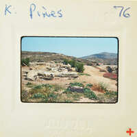 Old photo of a desert landscape with rocky ruins and sparse vegetation, taken on June 7th, 1976.