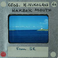 A vintage film strip with a picture of the ocean and islands on it.