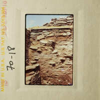 An aged photograph of an old stone building.